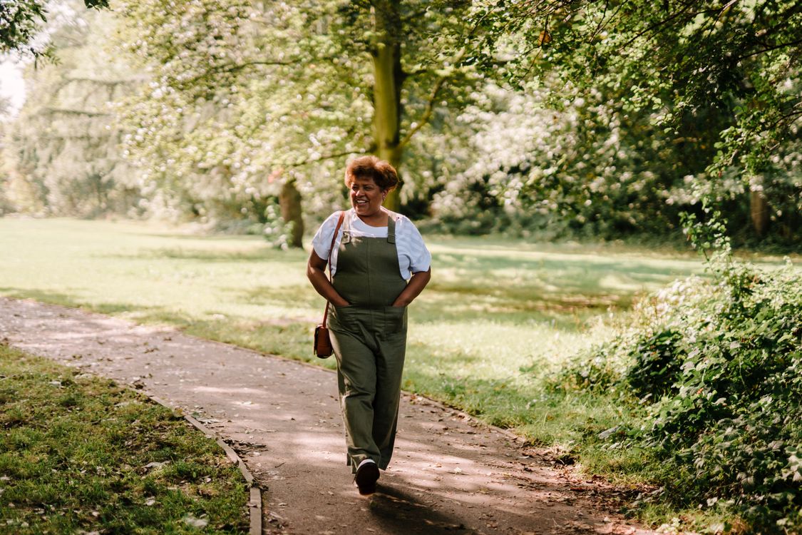 Woman walking outdoors as part of a sustainable hormonal belly health routine
