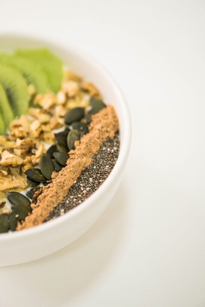 Colorful smoothie bowl with kiwi and seeds, one of several hormone balancing smoothie recipes