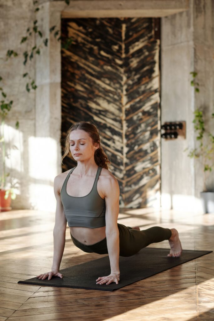Woman gently stretching as part of a moderate exercise routine for PCOS and hormone health