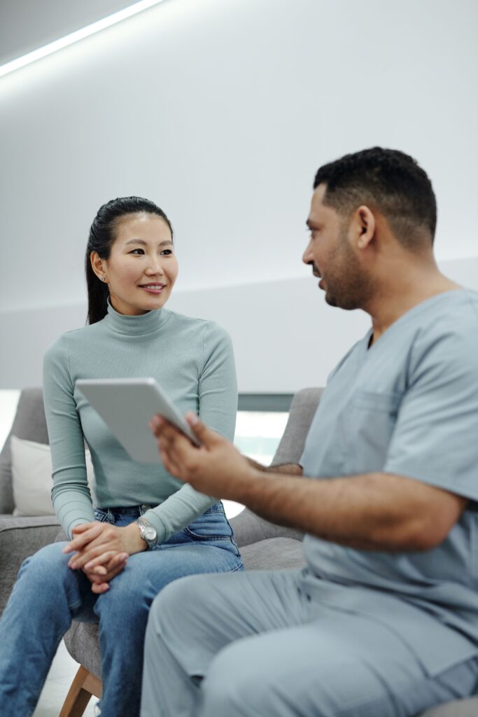 A woman in a warm consultation with her OB/GYN, discussing her health and pregnancy questions