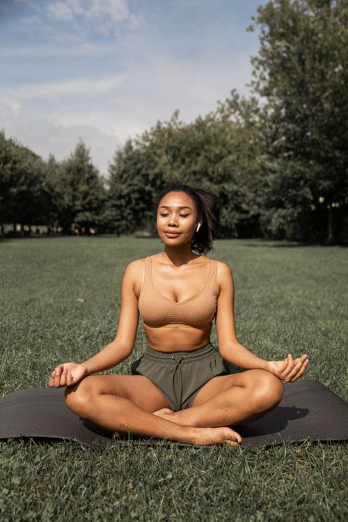 Woman practicing mindful movement outdoors to help balance hormones naturally