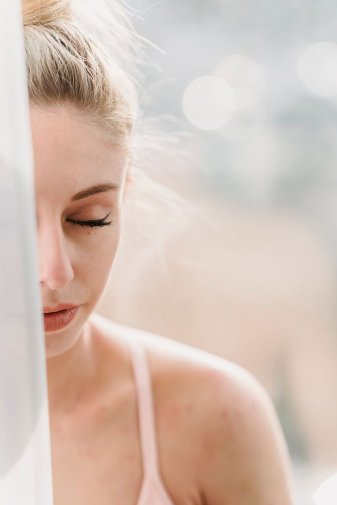 A woman sits peacefully in warm morning light, reflecting on the quiet toll hormonal imbalance can take on daily well-being