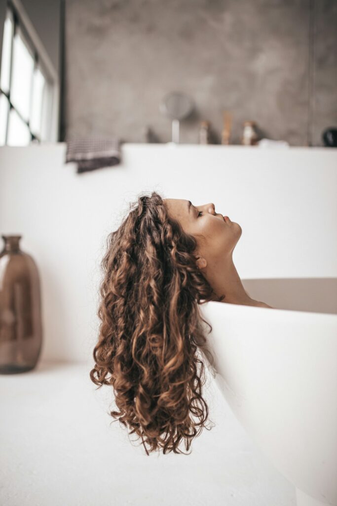 Woman relaxing in a warm bathroom during an everyday self-care moment