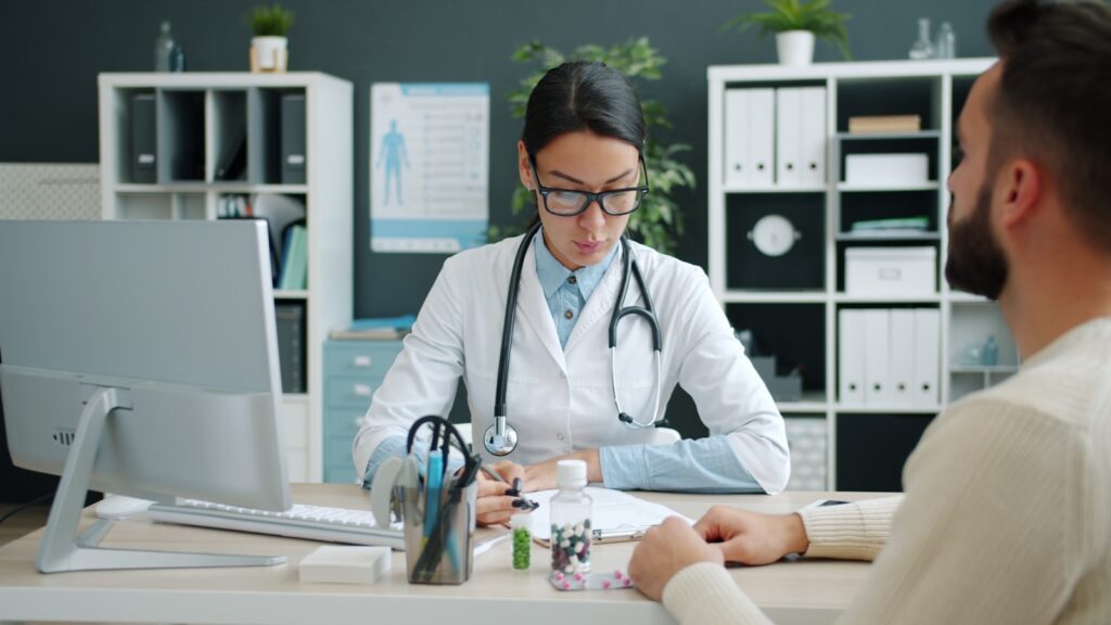 Doctor discussing chlamydia vs UTI test results with a patient during a consultation