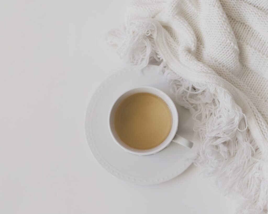 Warm cup of tea and a cozy blanket, a comforting home remedy for IUD cramps