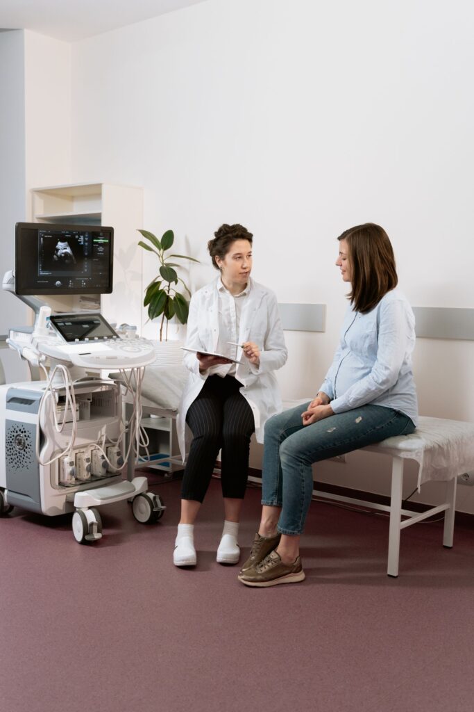Pregnant woman talking with her healthcare provider during a prenatal appointment