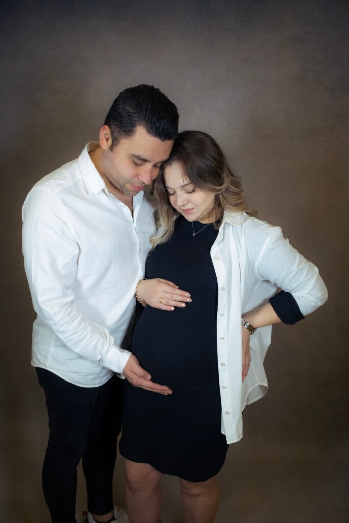 Pregnant woman and her husband, supporting each other through a high-risk pregnancy