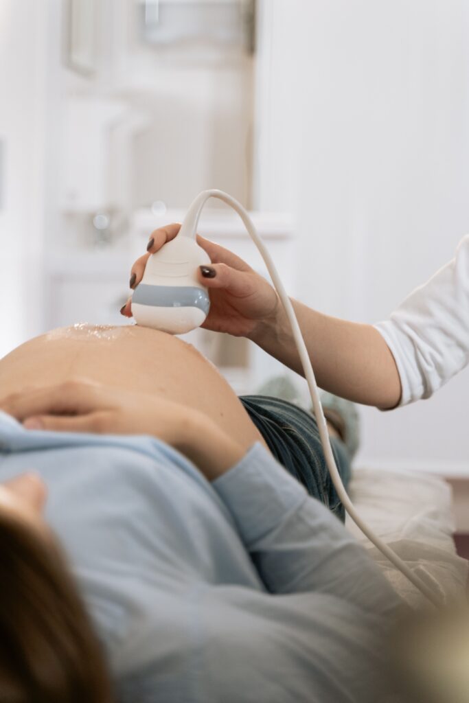 Pregnant woman receiving an ultrasound examination, important monitoring for a high-risk pregnancy